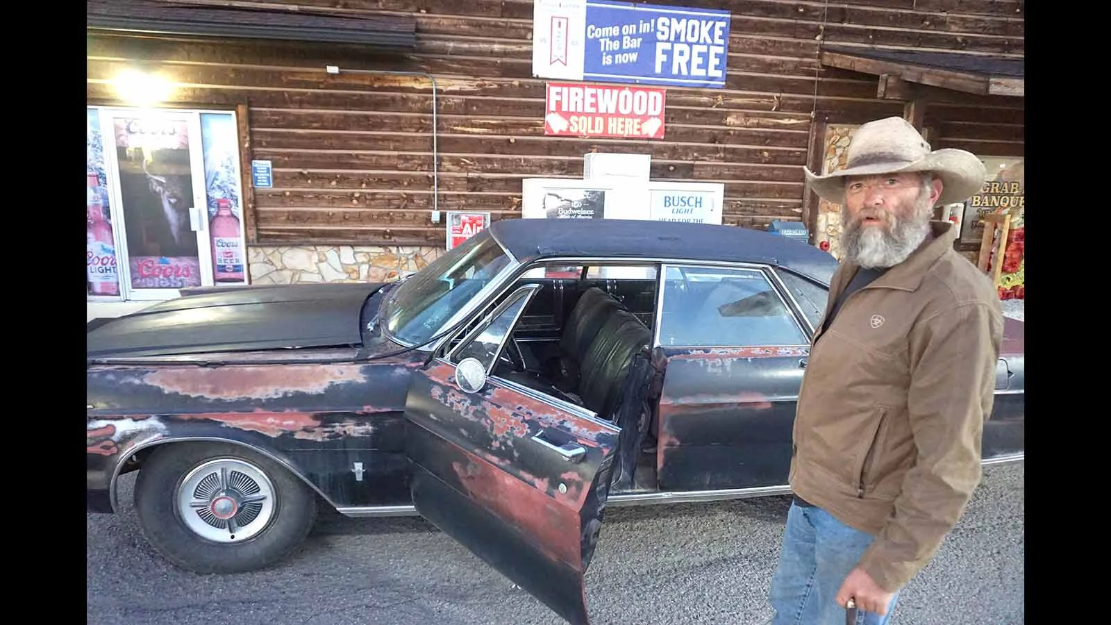 Third-generation Boulder Bar owner Burke Steele enjoys a cigar, a beer and his rusted 1965 Ford Galaxie when not running the bar.