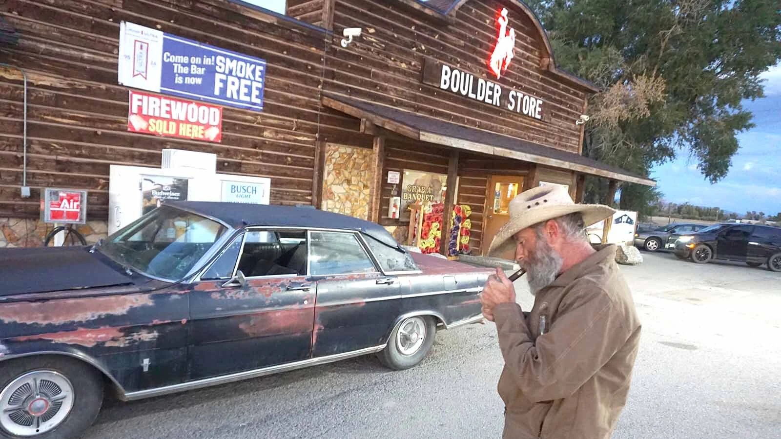 Third-generation Boulder Bar owner Burke Steele enjoys a cigar, a beer and his rusted 1965 Ford Galaxie when not running the bar.