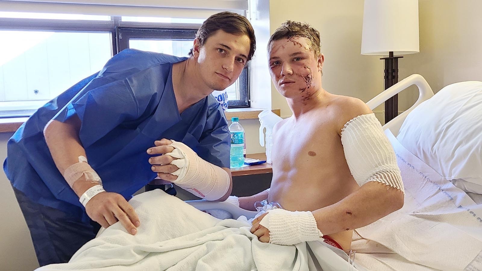 Brady Lowry, left, and Kendell Cummings after being mauled by a grizzly near Cody in October 2022. The bear was attacking Lowry when Cummings jumped on its back to save his friend.