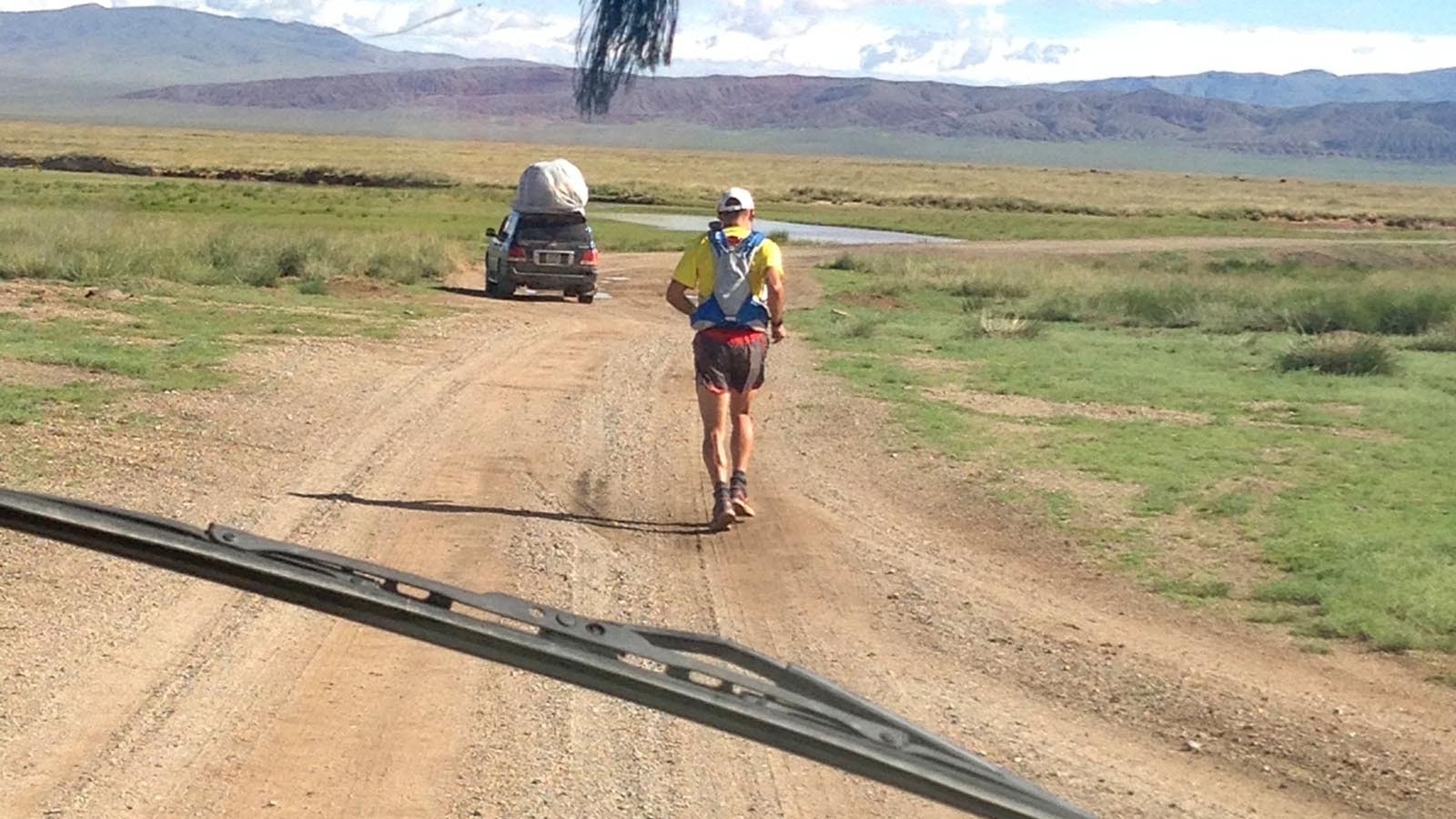 Brian Hunter runs ahead of his wife, Lissa, in one of the support vehicles during his 1,500-mile run across Mongolia.