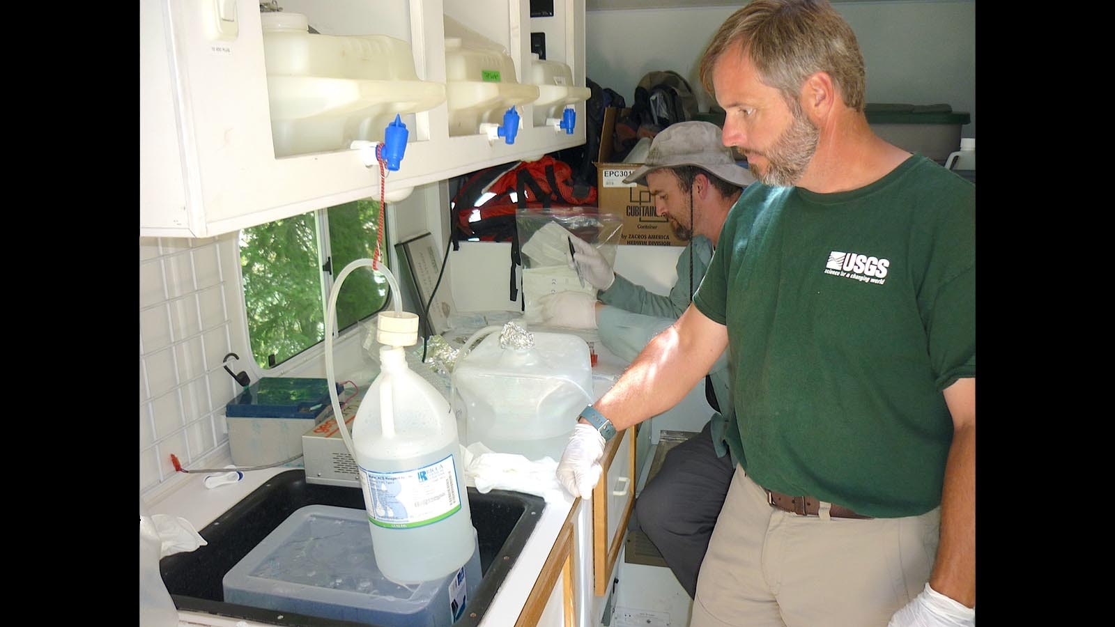 Elliott Barnhart, foreground, in the lab truck to processing hot springs water samples.