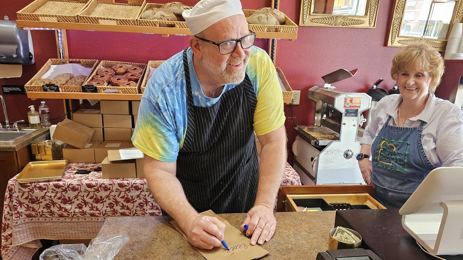 Edzan Fluckiger likes to write the names of his customers on their to-go lunch orders.