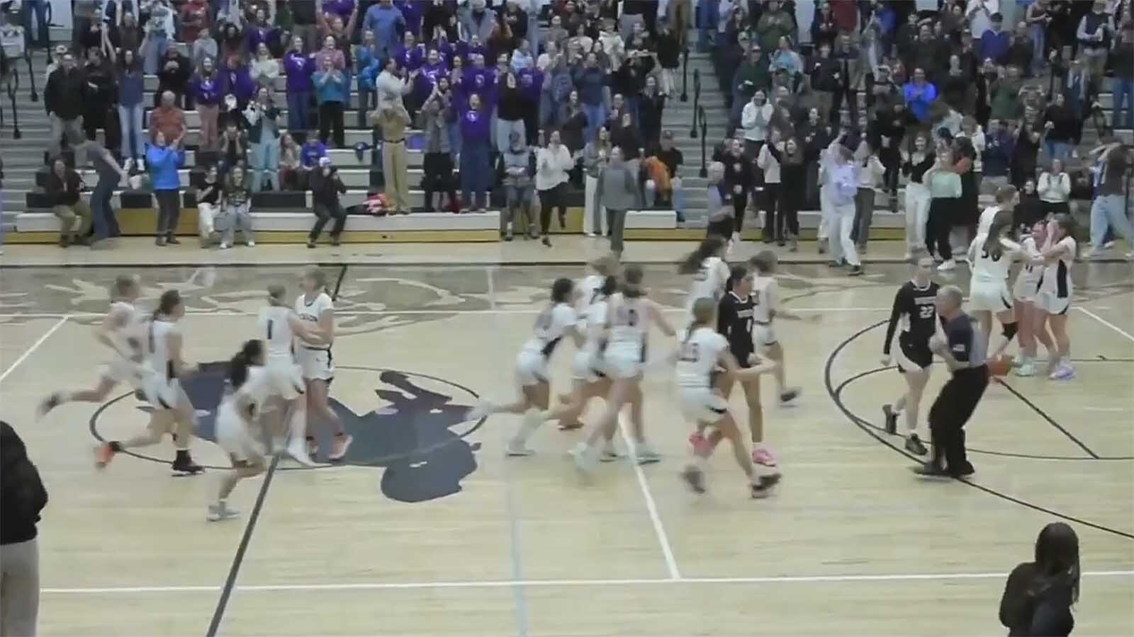 Players rush the floor after Sophomore shooting guard Ari Fowler nailed a 3-pointer with 5 seconds left against Riverton on Feb. 20, 2025, to snap Jackson Hole High School’s 79-game, four-year girls’ basketball losing streak.