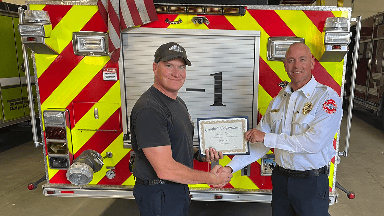 Casper firefighter Brian Dixon, left, is recognized for 20 years of service to the Casper Fire-EMS Department by Chief Jacob Black.