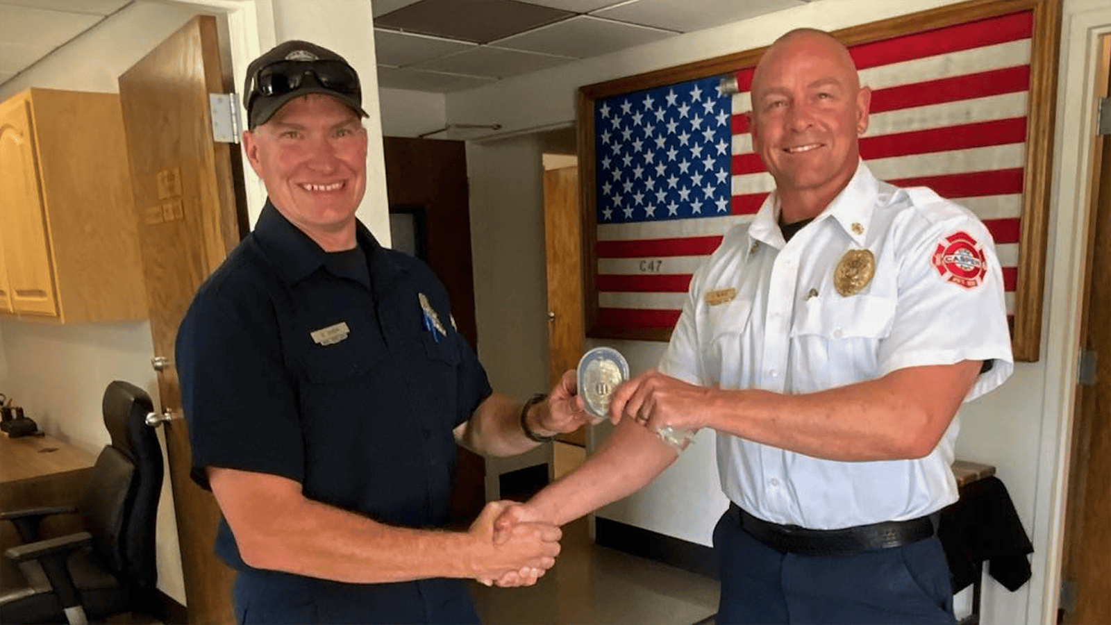Casper firefighter Brian Dixon, left, is promoted to captain by Casper Fire-EMS Department Chief Jacob Black.
