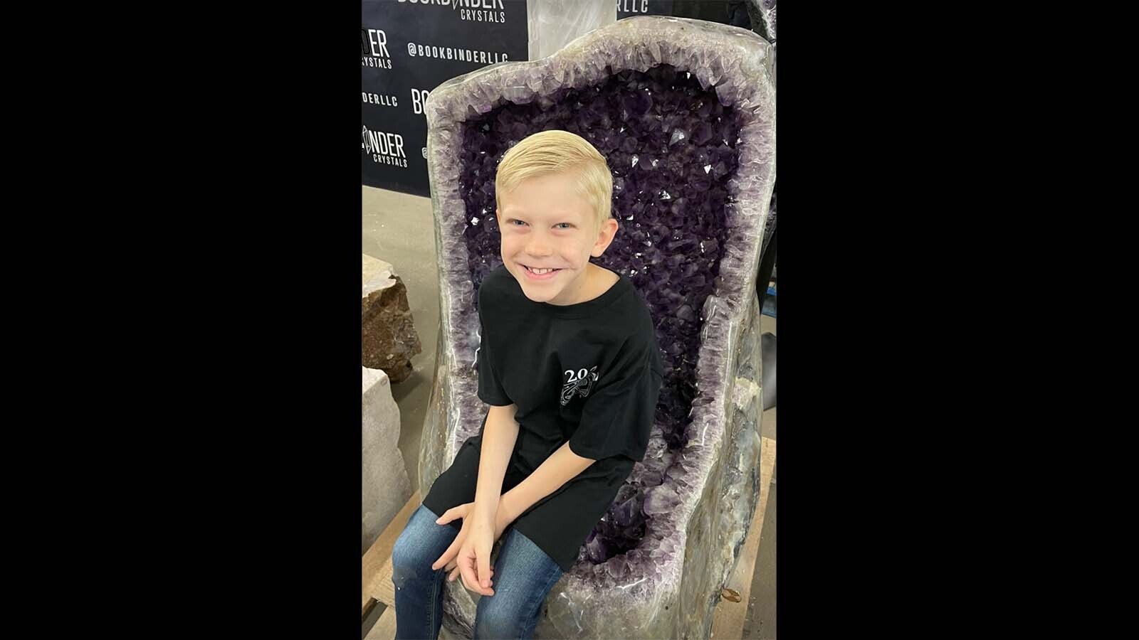Bridger Walker loves rocks. Here he checks out a gem of a chair at a rock show.