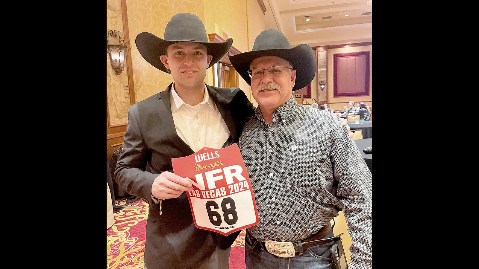 Brody Wells, left, and his father Ed Wells at the 2024 National Finals Rodeo in Las Vegas.