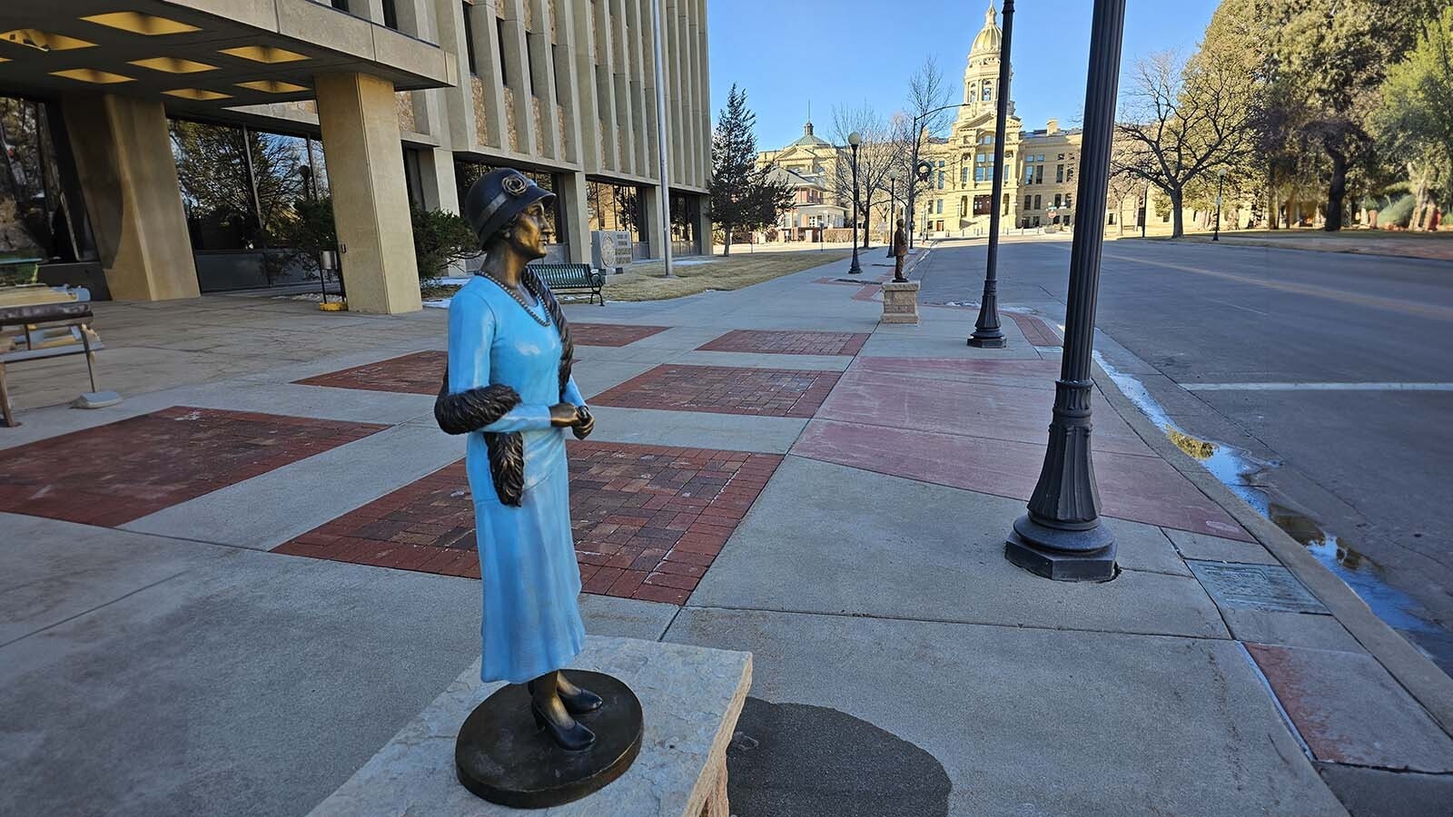 Nellie Tayloe Ross, first female Wyoming governor, looks sharp as if about to turn and walk to Wyoming’s state Capitol in the background.