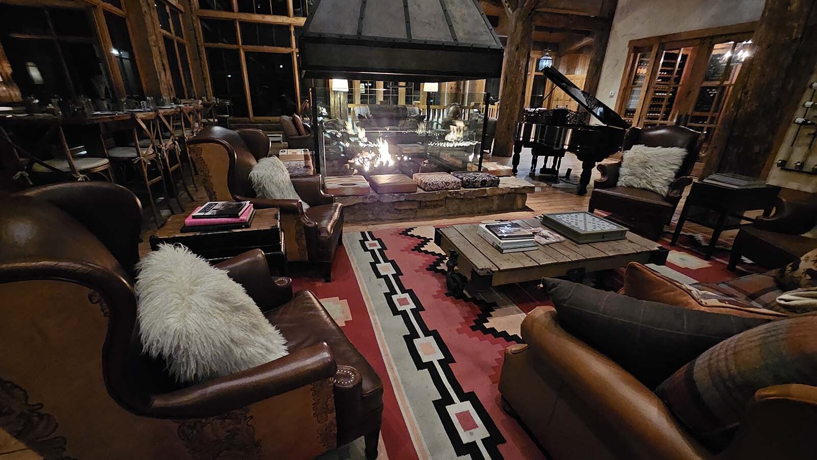 A gas furnace with cozy pillows invite visitors to sit a spell while books about the West invite reading.