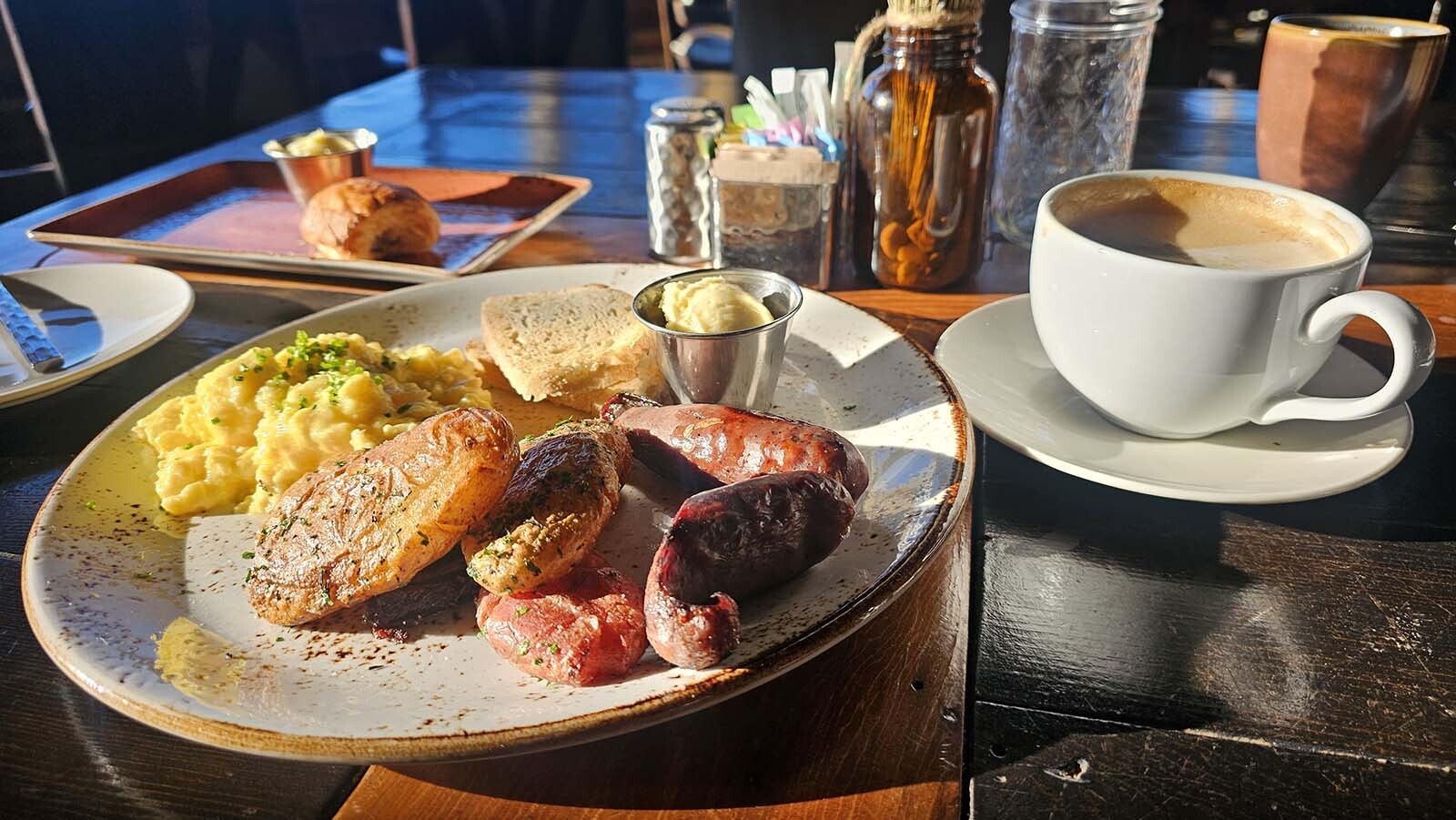 The scrambled eggs your way looks a lot like how Gordon Ramsey prepares his eggs. Gooey and soft, with a sprinkle of fresh herbs. The meal is rounded out with tallow potatoes, sourdough toast, and wild game sausages.