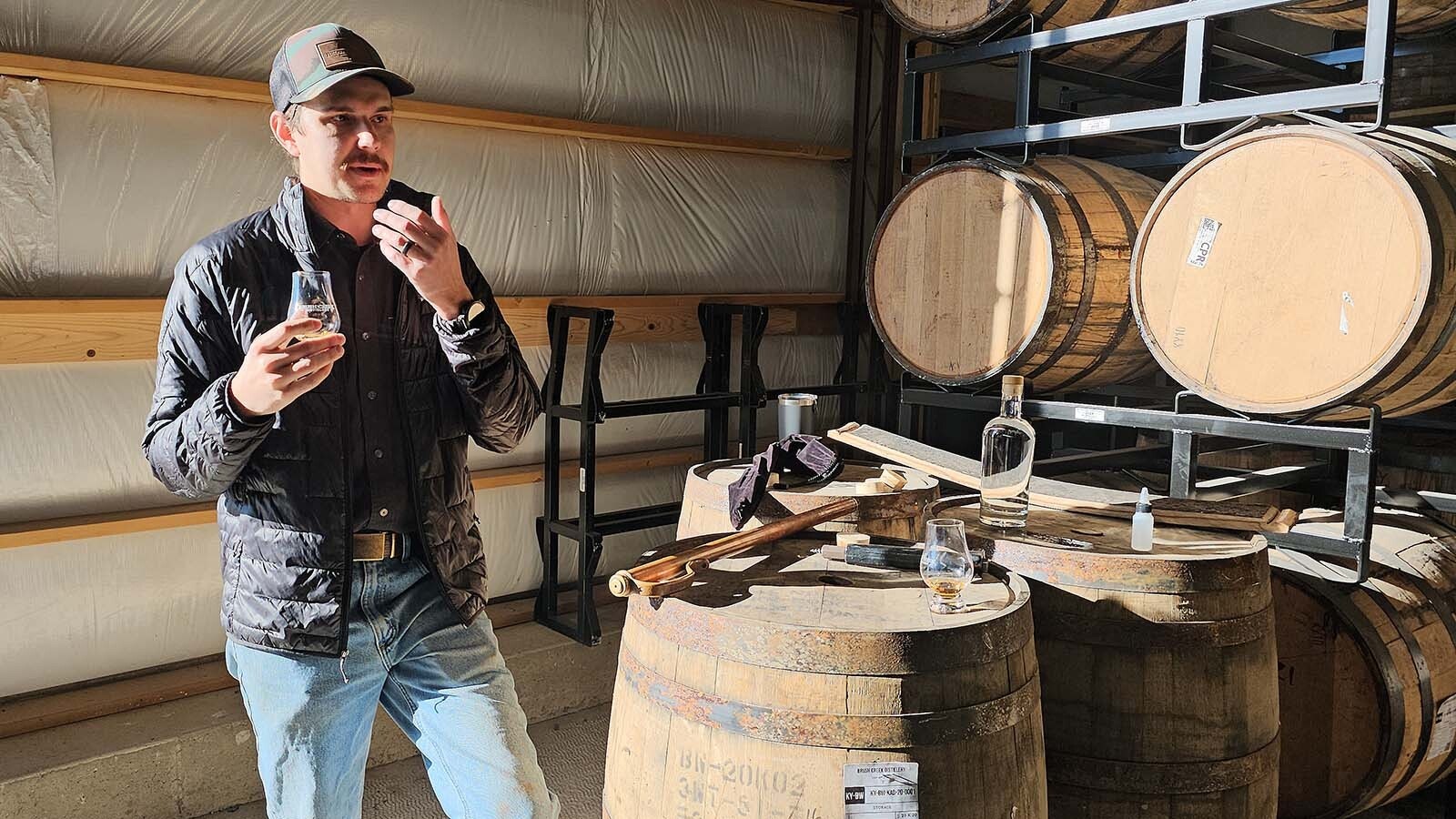 Brush Creek Ranch Lead Distiller Ethan Whitman demonstrates how to taste a glass of 120-proof whiskey.