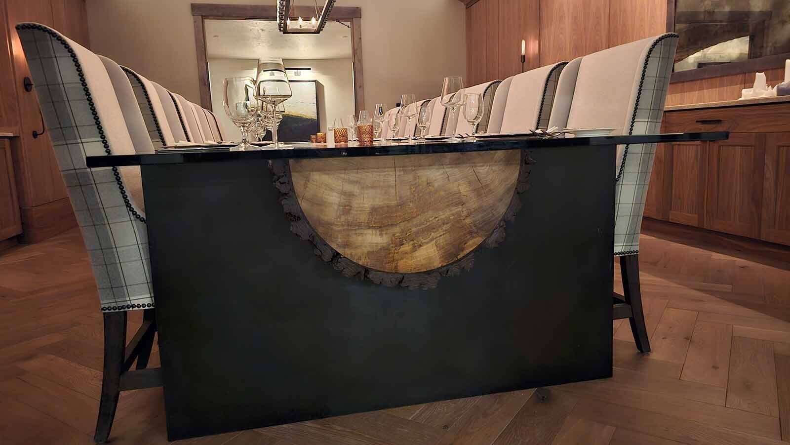 The Founders Room table at Brush Creek Ranch seats 12. It was made with a continuous log from a tree that was cut in half.