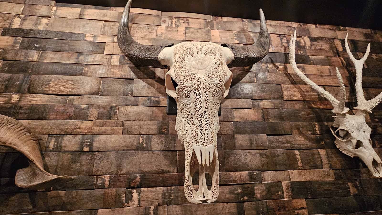 Much of the artwork that adorns the walls in Brush Creek Ranch's wine cellar have a western flair, like the lacy animal skulls.