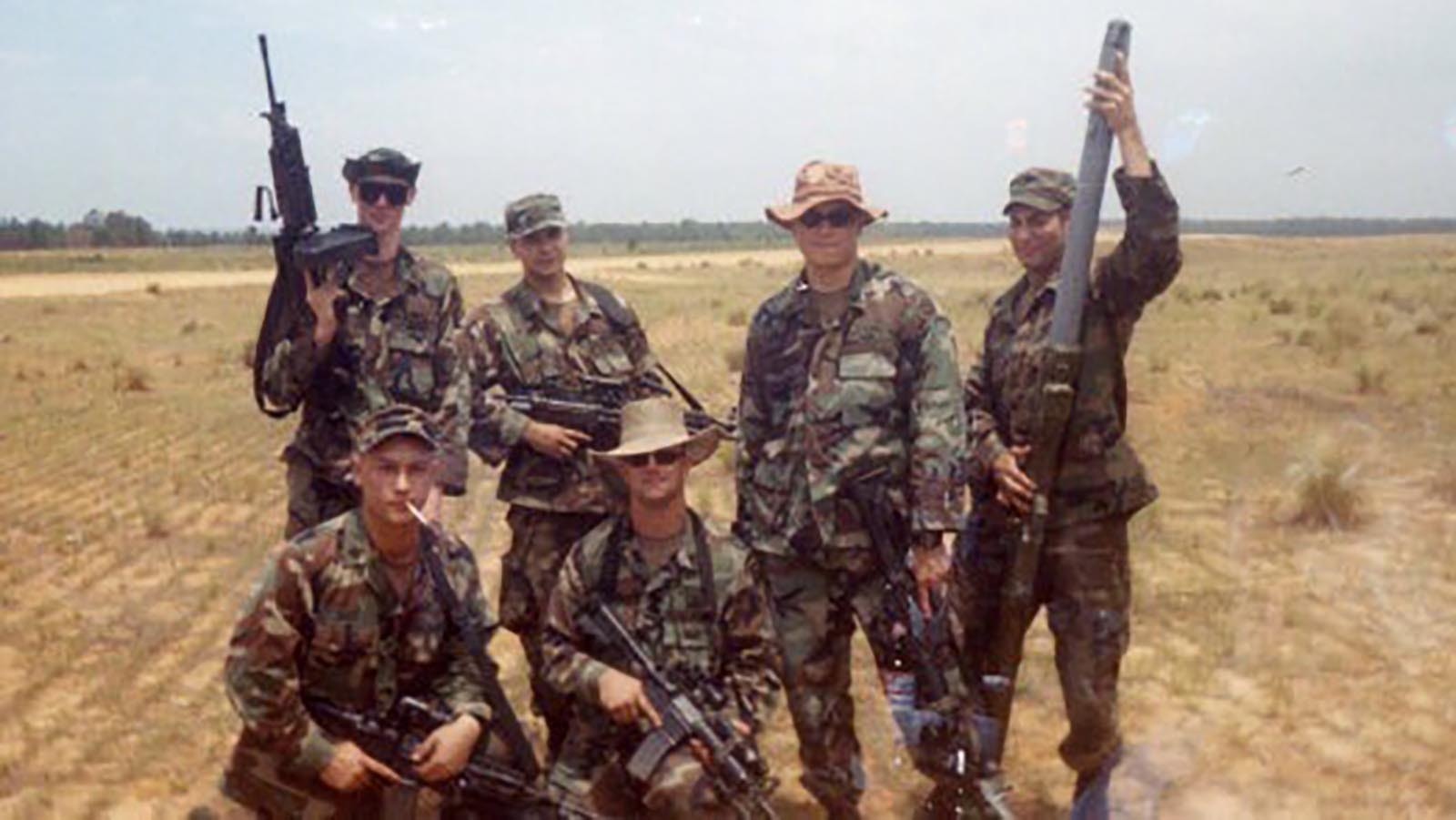 Bryan Price, top left, in the field with a team during his army career.