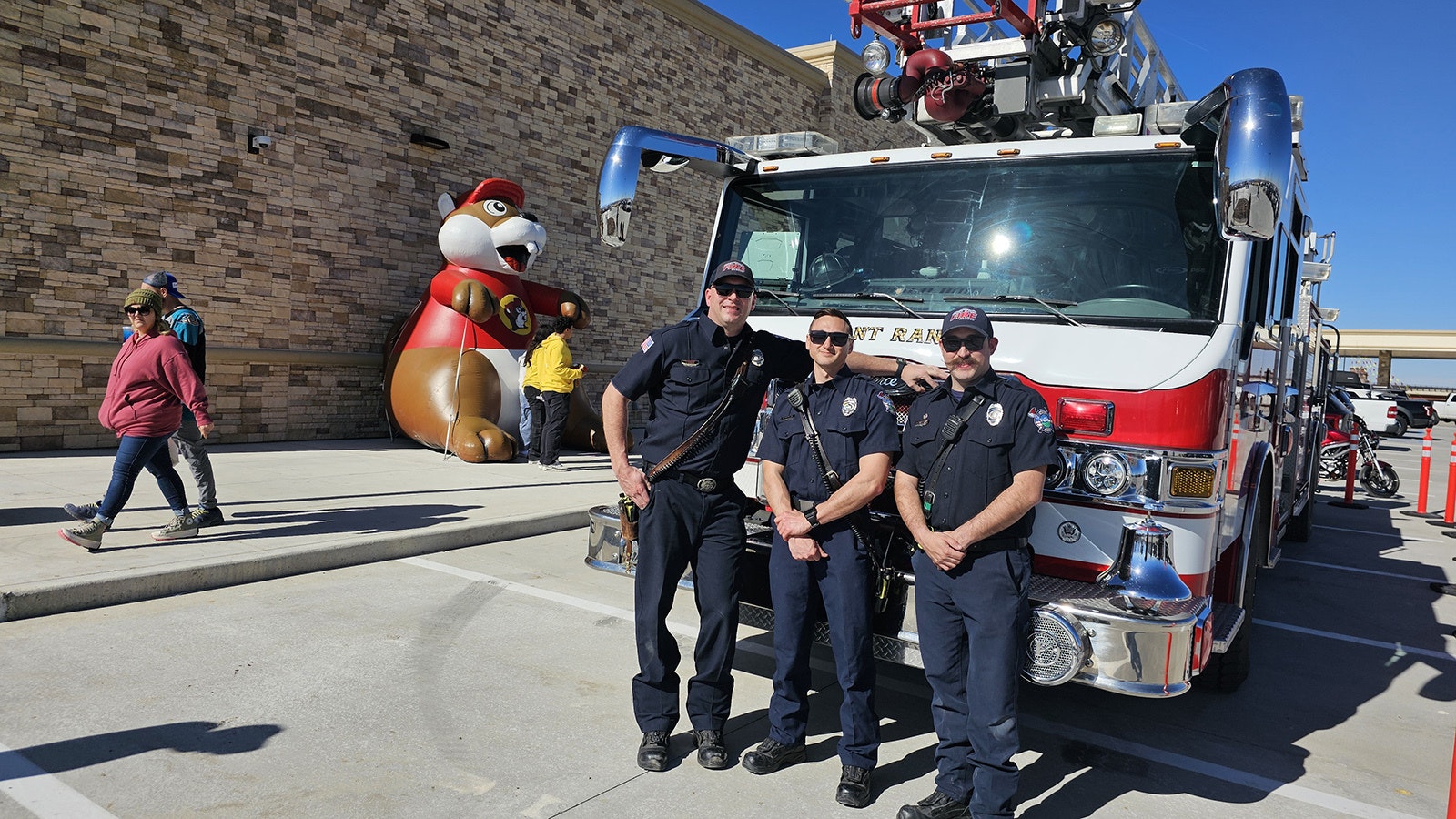 Jay Beine, from left, Connor Covillo and Dustin Easley were on standby outside of Buc-ee's in Johnstown, Colorado, just in case of an emergency with so many people on site at once.