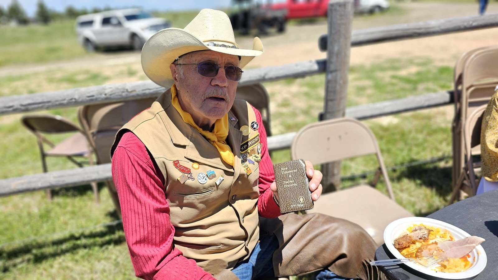 Ron Broten holds up the Bible he carries as part of the Pony Express. He helped lead the pony riders to Buckboard Sunday at Esterbrook Church.