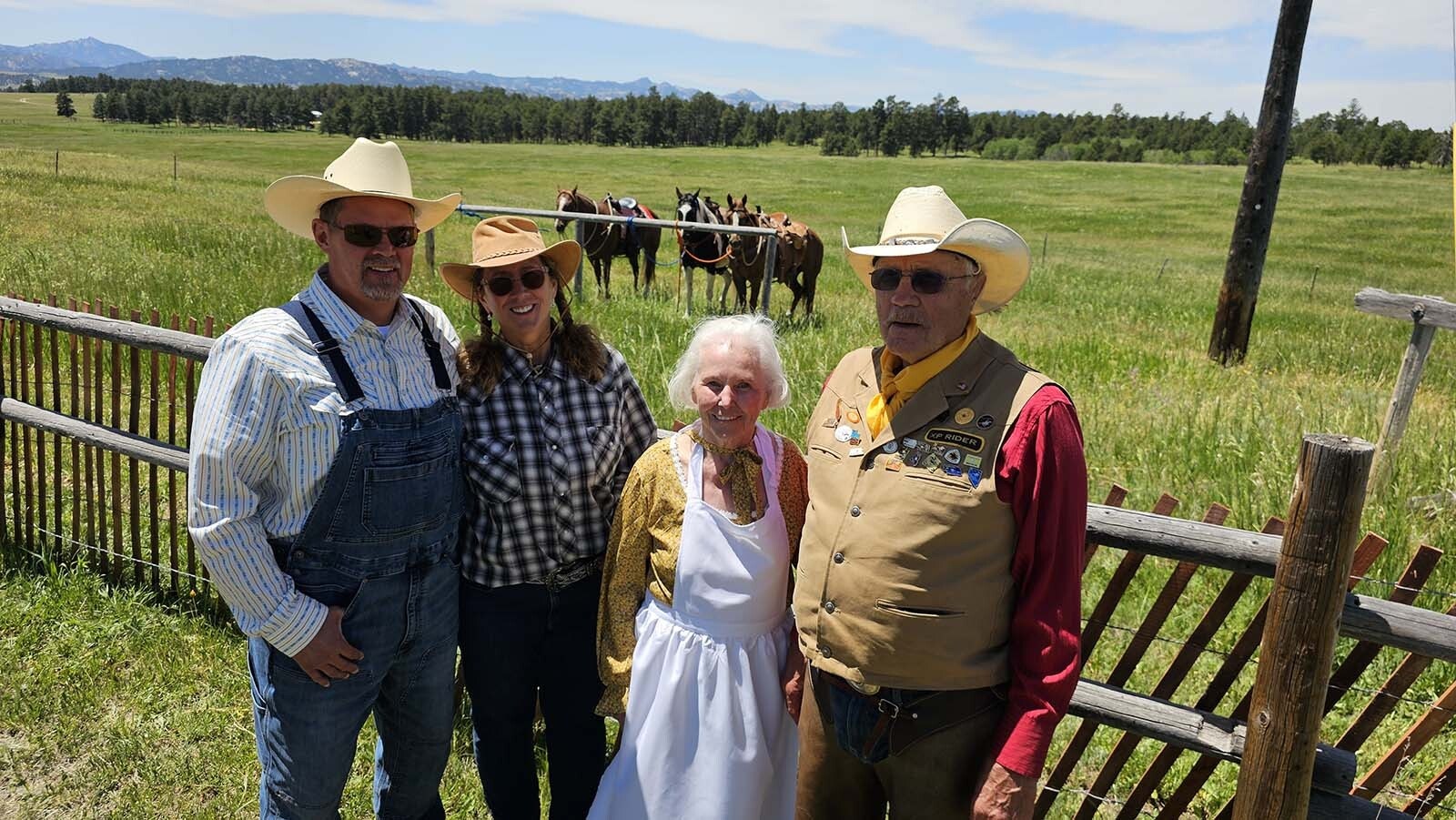 From left, Errin and Lynnae Kolden pose with Mary and Ron Broten for a photo in front of the horses they rode to Buckboard Sunday.