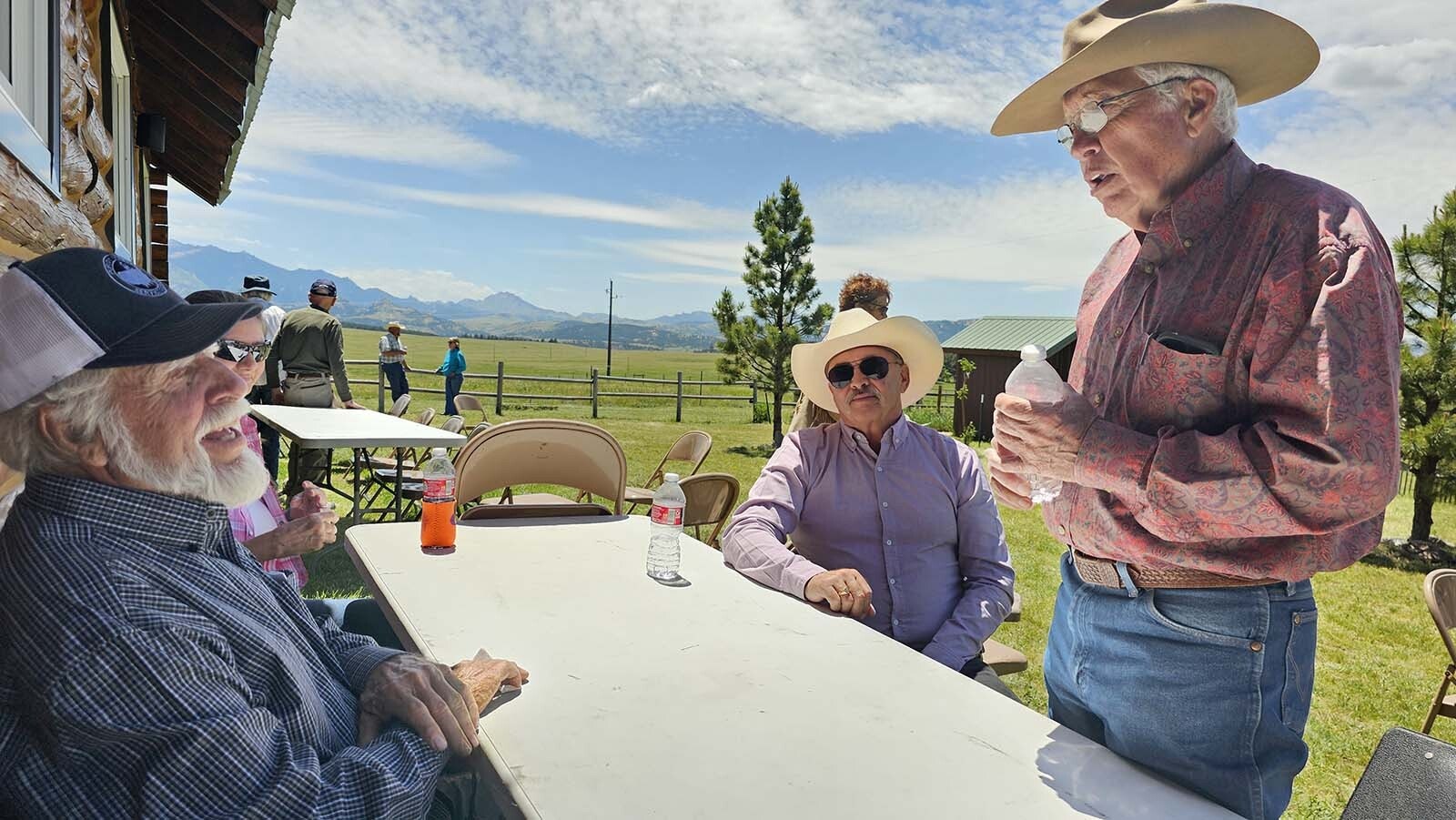 Steve "Shakey" Chadwick, front left, talks to friends during Buckboard Sunday after the potluck lunch.