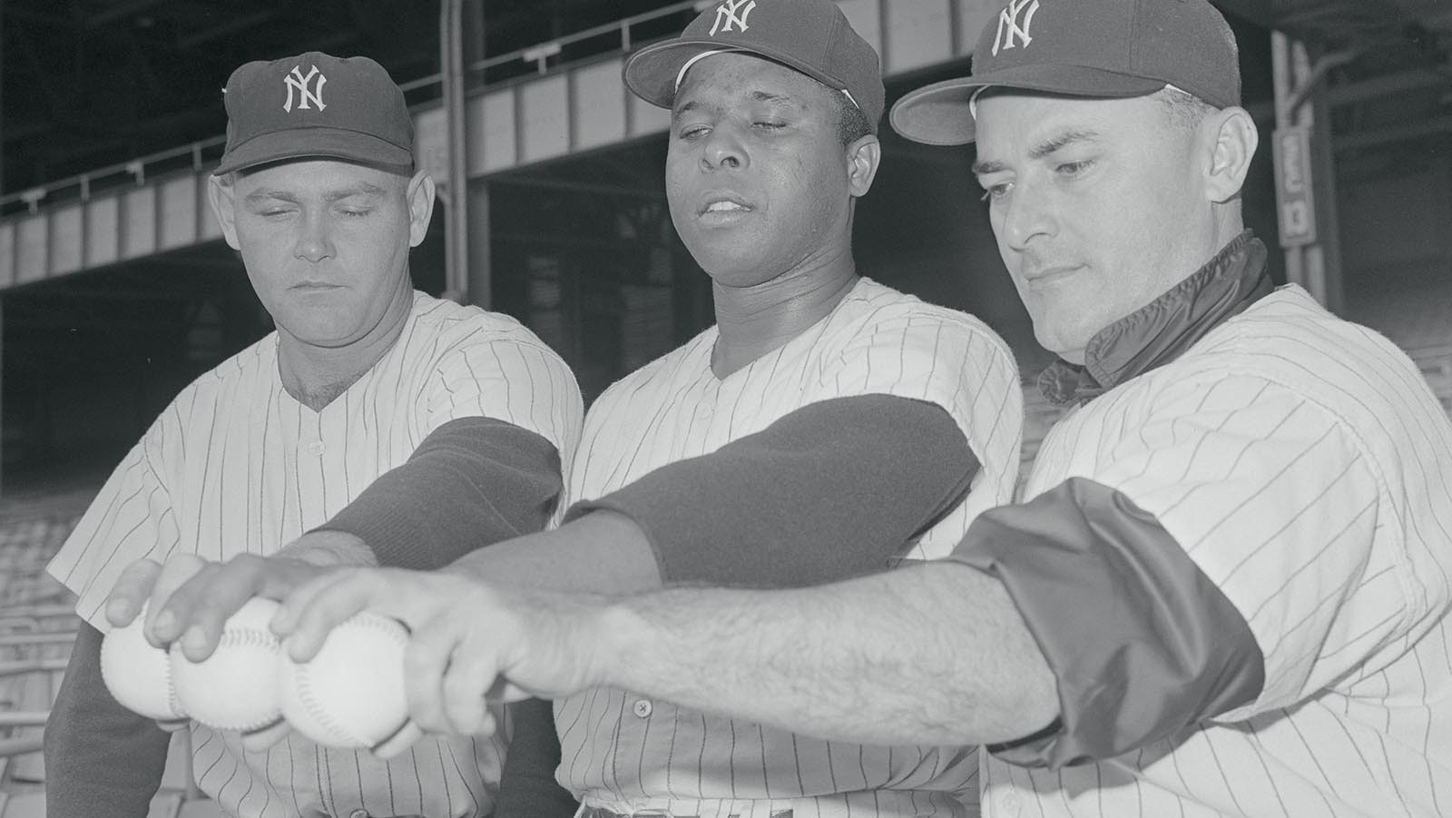 Left-handed pitchers, from left, Bud Daley, Marshall Bridges and Luis Arroyo grip baseballs.