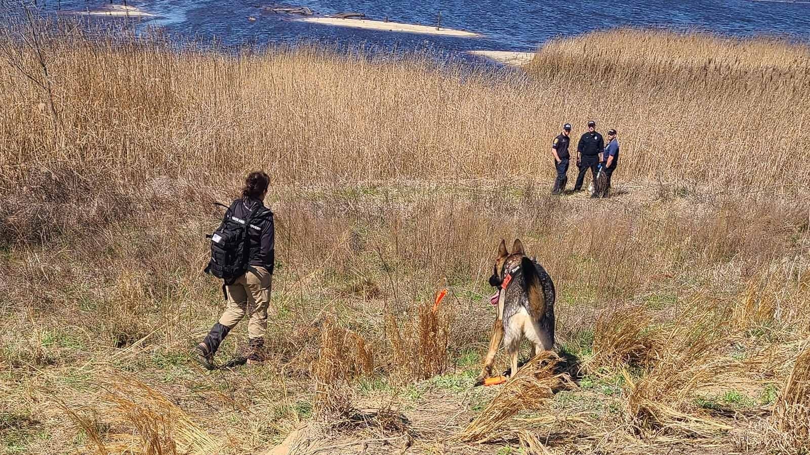 Bueno in the field with law enforcement and his handler, Brandy Eggeman.