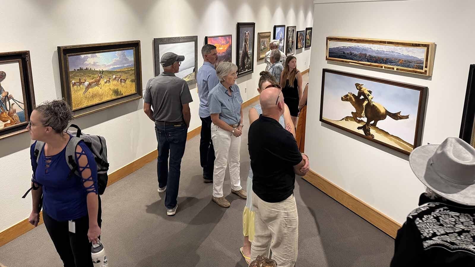 People meet, mingle, and admire the 103 pieces of art selected for the 44th Buffalo Bill Art Show and Sale.