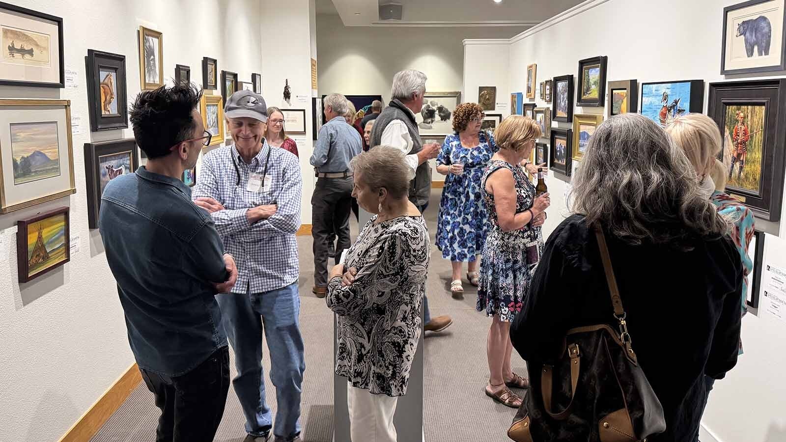 Patrons peruse the Buy-It-Now Sale gallery during the opening of the 44th Buffalo Bill Art Show and Sale. These pieces are donated by artists selected for the live auction, offering smaller, more affordable works that can be purchased anytime during the duration of the show.