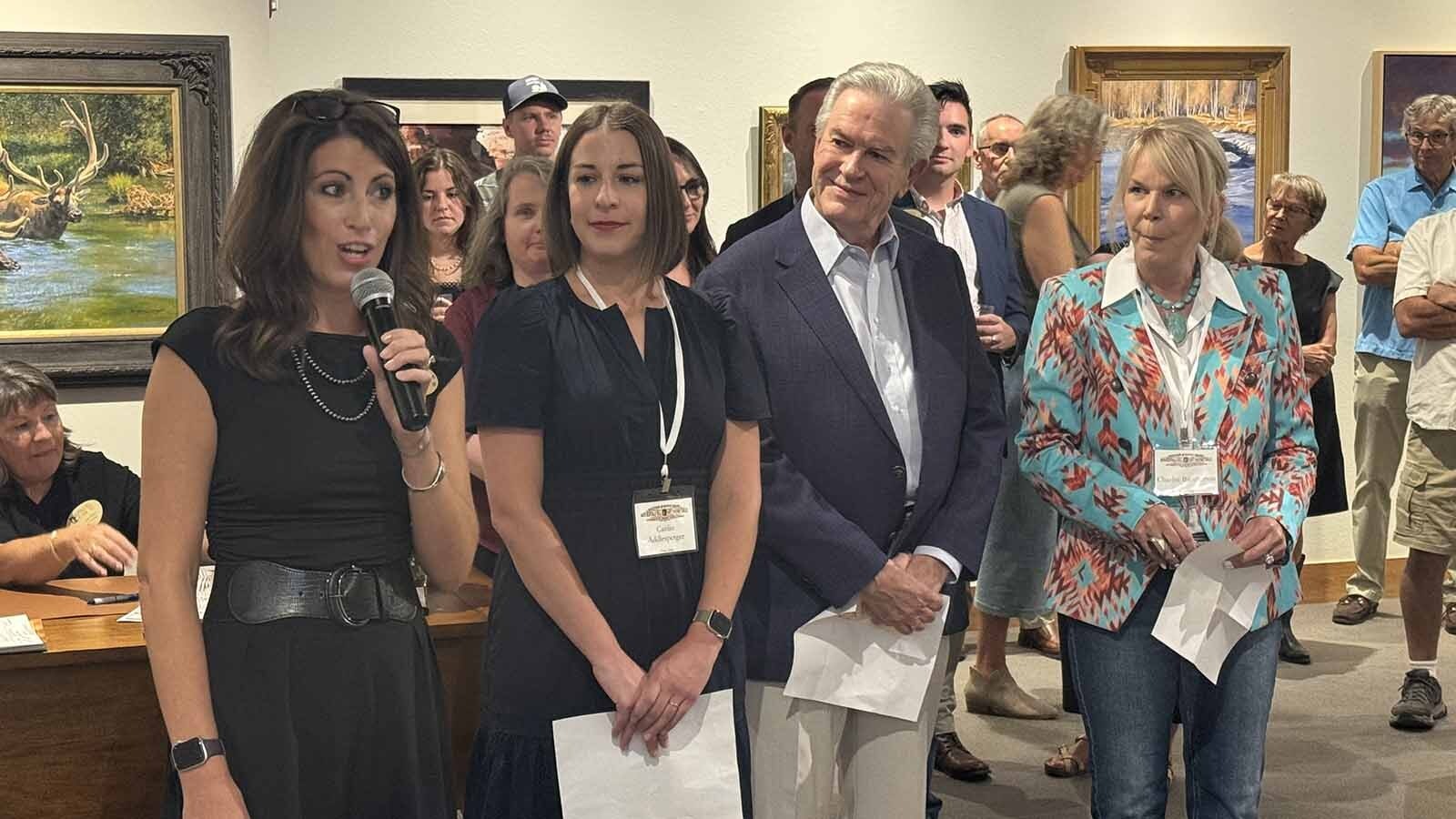 Katelyn Parker, director of the Buffalo Bill Art Show and Sale, introduces the three judges of the 2025 show during the gallery's opening night at the Buffalo Bill Center of the West in Cody. Judges are chosen to represent three realms of the fine art world: business, patrons, and curators.