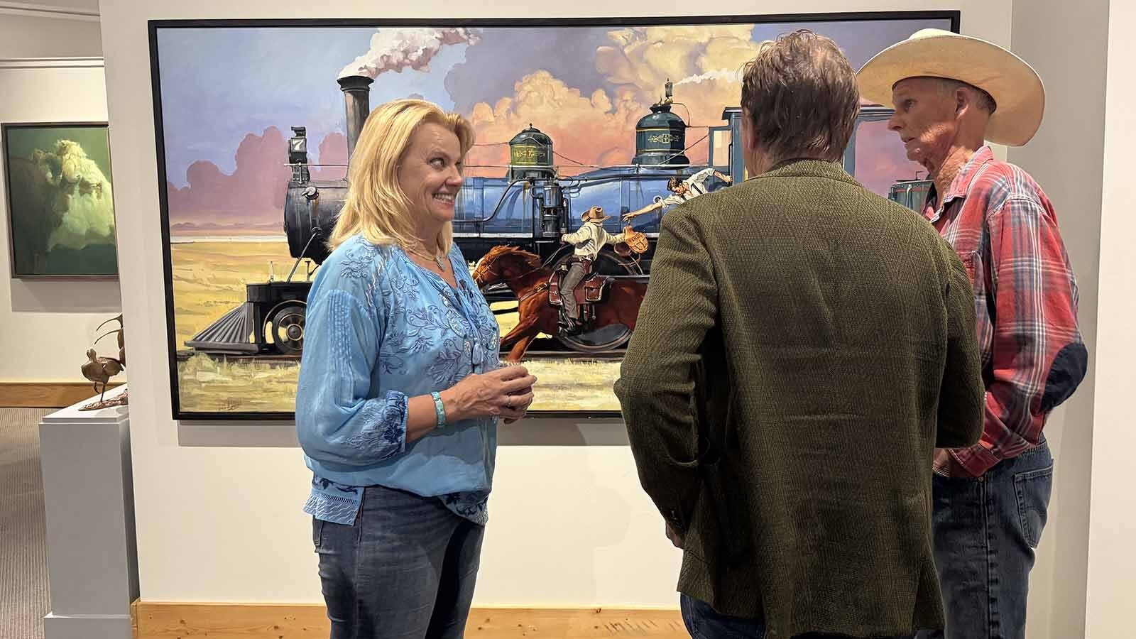 Patrons admire "A Matter of Utmost Urgency," an oil painting by Santiago Michalek, at the opening of the 44th Buffalo Bull Art Show and Sale. This painting won the "Spirit of Buffalo Bill Award," the most prestigious of the show's adjudicated awards.