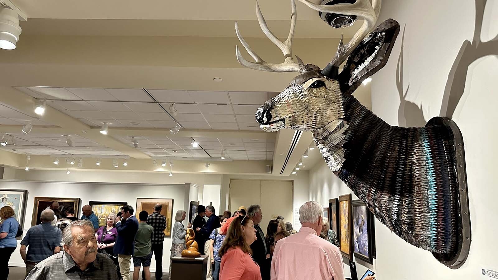 William Pete Emmons contemplates "Great Plains: Mule Deer" by Denver artist Dolan Geiman. Every piece included in the Buffalo Bill Art Show and Sale comes from a contemporary Western artist. Many artists attend the live auction in September to see how high the bidding goes for their art.