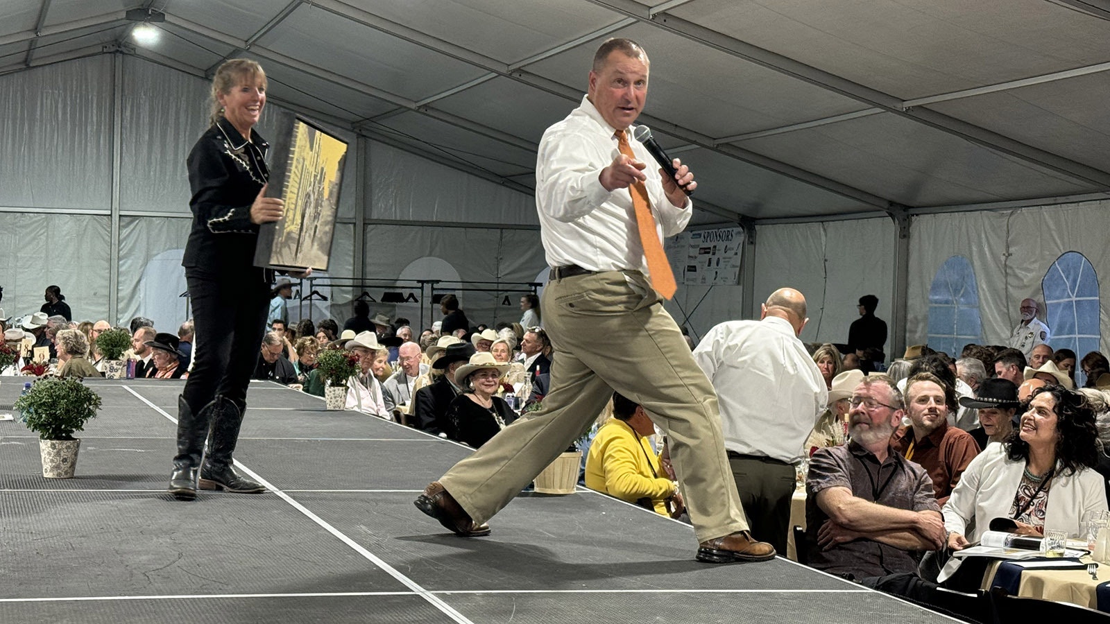 Auctioneer Troy Black adds fire to the bidding war for "Cielo Amarillo" by Gordon McConnell at the 43rd Buffalo Bill Art Show and Sale's live auction. The piece sold for $6,500.