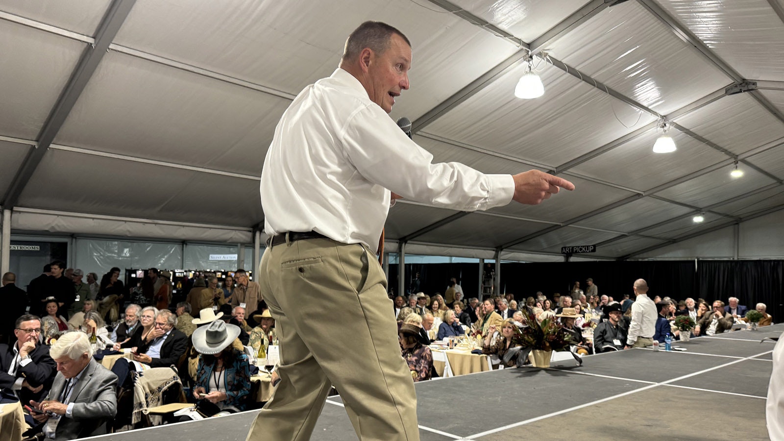 Auctioneer Troy Black takes no excuses during the 43rd Buffalo Bill Art Show and Sale. He's been the auctioneer for the show for nearly two decades and knows most of the patrons well enough to joke and rib them into bidding higher.