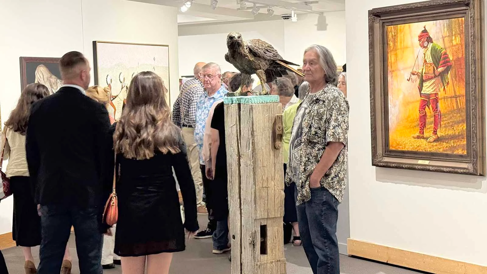 Patrons admire some of the 107 pieces of modern Western art that will be displayed and auctioned off during the opening of the 45th Buffalo Bill Art Show and Sale.
