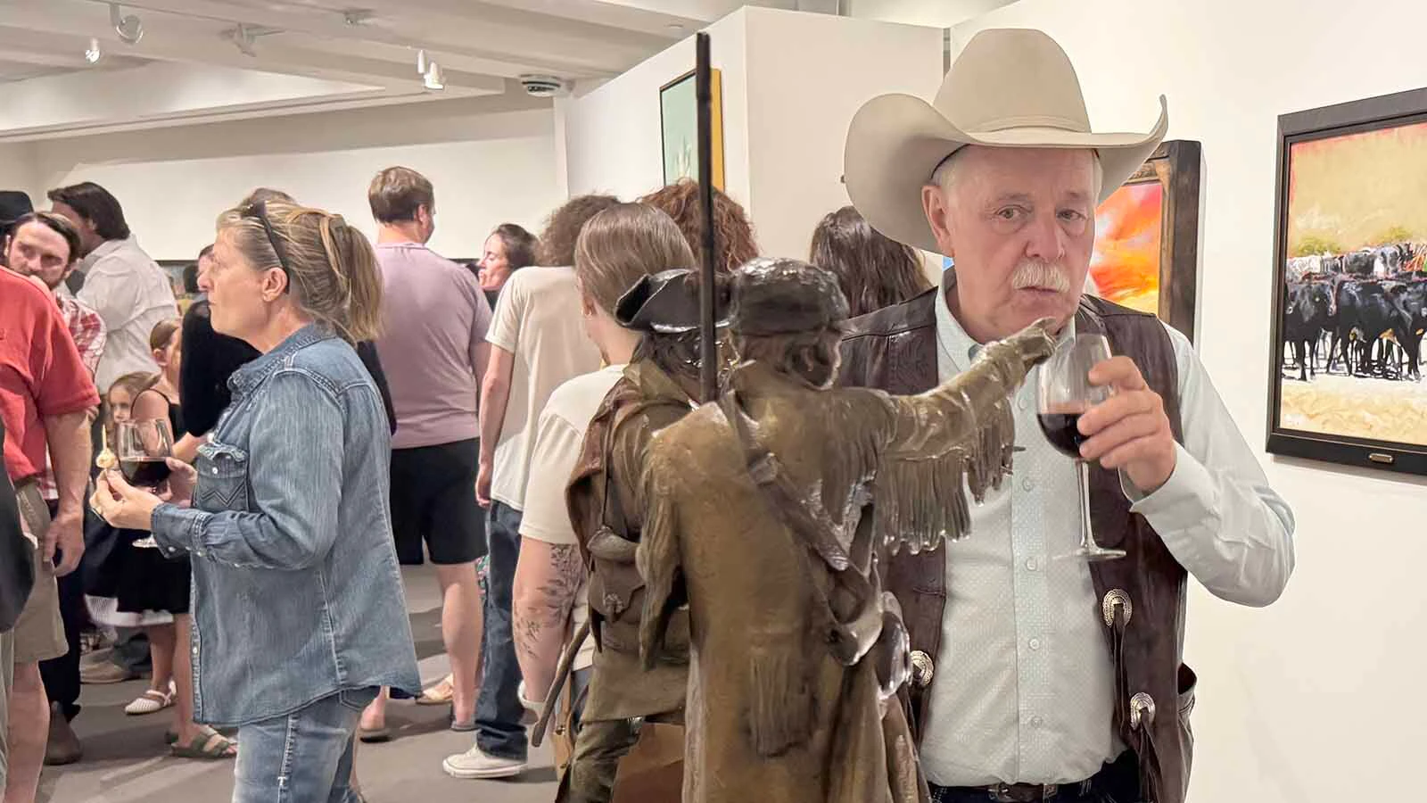 Sculptor Vic Payne stands next to "Dawn of America," a bronze sculpture that won the 45th Buffalo Bill Art Show and Sale's Three-Dimensional Award.