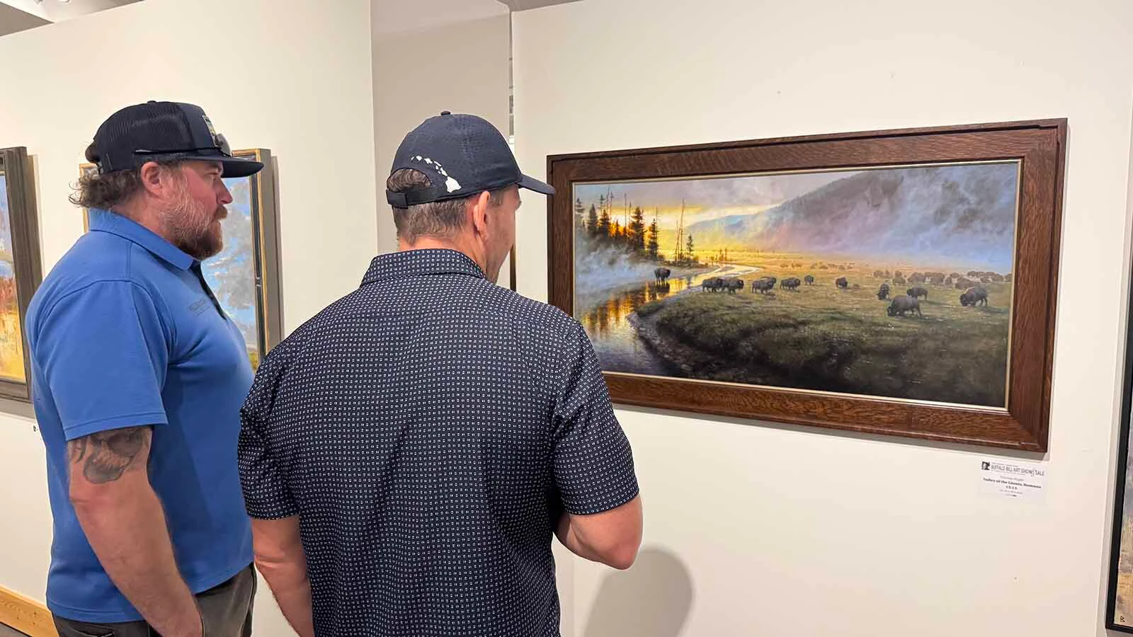 Patrons viewing "Valley of the Giants, Romans 15:13," an oil painting by Thomas Kegler, during the opening of the 45th Buffalo Bill Art Show and Sale. This painting won the coveted Spirit of Buffalo Bill Art Show and Sale Award, the highest honor bestowed on any piece each year, by unanimous vote of a panel of five judges.