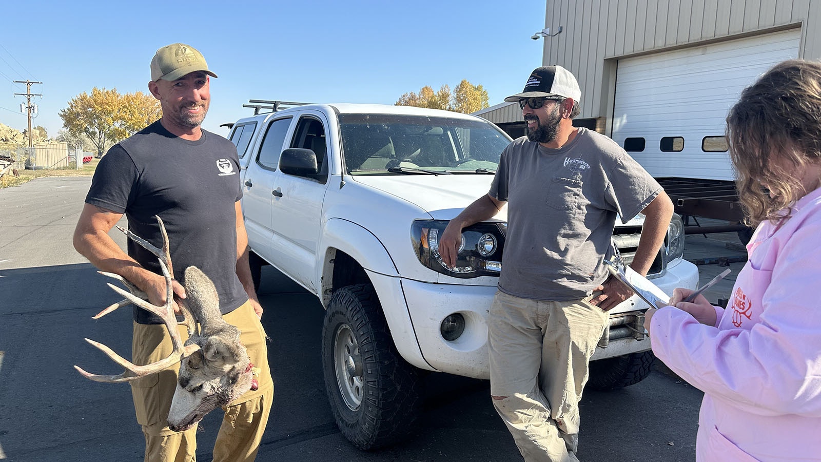 Susannah Corlett checks in a deer head from a customer and makes sure his license is correct before accepting the head for processing.