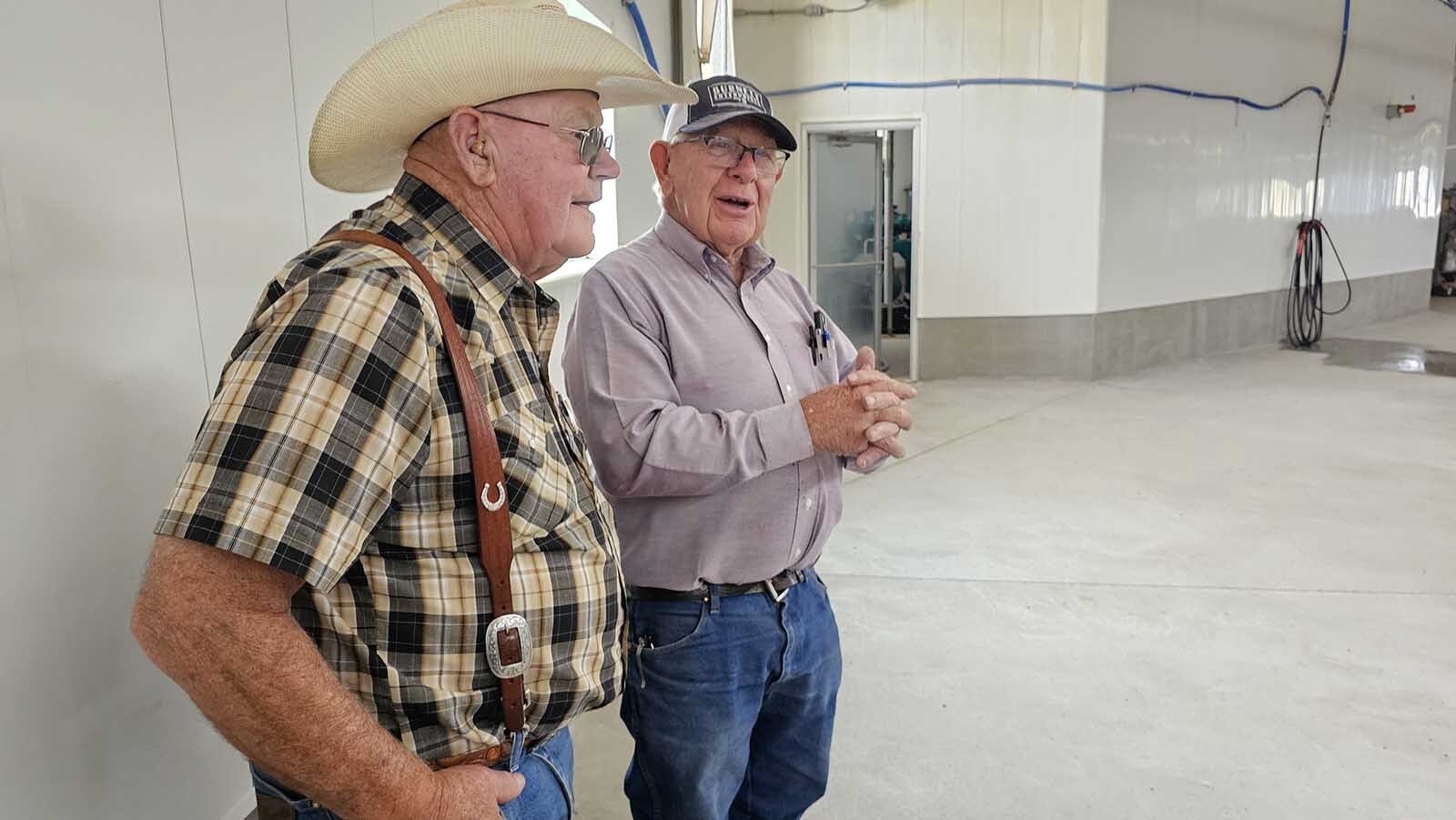 Jerry Burnett talks with a member of the Centennial Antique Tractor & Engine Club about the mega dairy he and his sons have built near Carpenter, Wyoming.