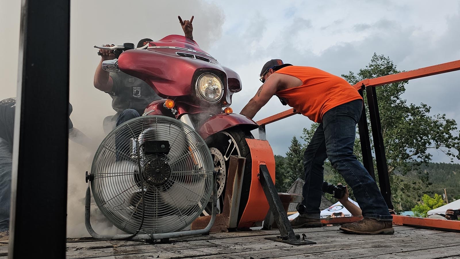 Cory Rand of Wisconsin puts up his horns during the Sundance Burnout. This was his first time purposely trying to blow out a tire.