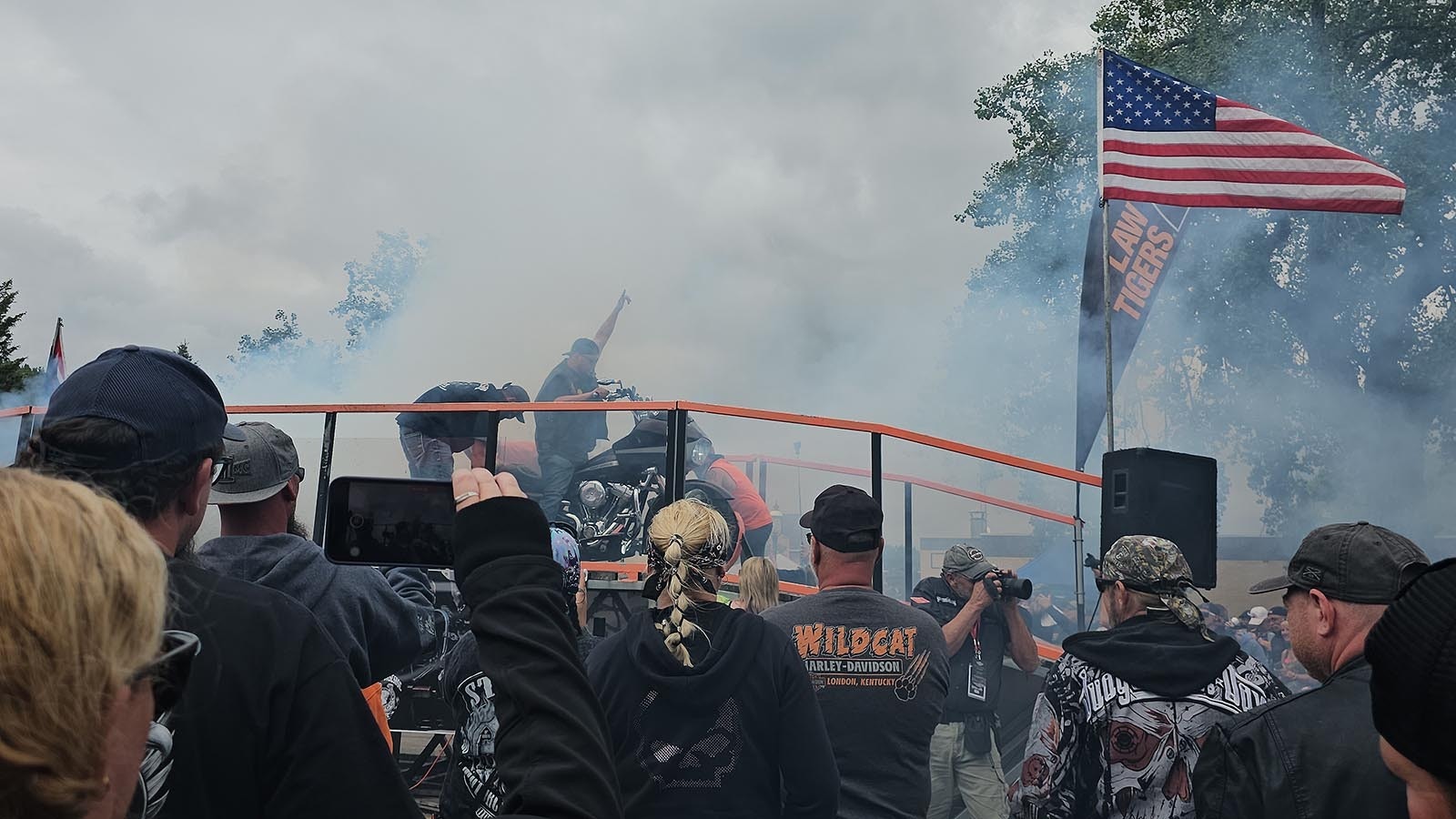 The crowd is cheering and video is recorded of a Burnout contestant's ride in Sundance.