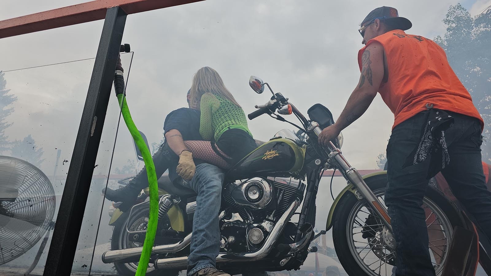 Jess Jones gives her husband Casey a kiss after their first burnout exhibition ride together.