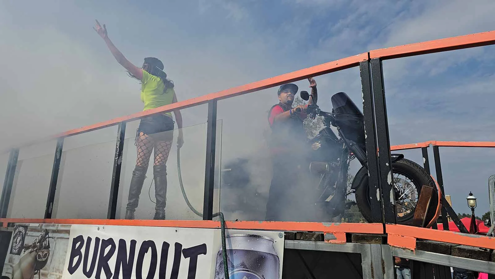 Dime Horseshoe Bar owner Jess Jones urges the crowd to cheer for Raymond Felix's burnout ride in Sundance. Felix took third place in the contest. The burnout happens every year during the Sturgis Rally.