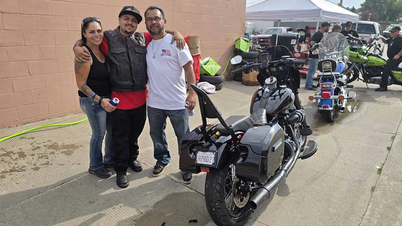 Raymond Felix, center, poses with mom and dad, Alisa and Leon Felix, during the Dime Horseshoe Bar's annual burnout in Sundance during Sturgis Rally week.