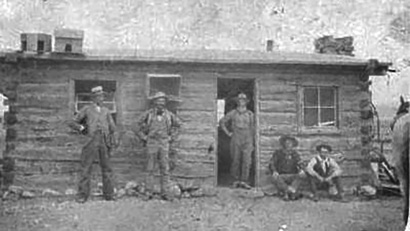 This photo reportedly shows Butch Cassidy and Hewitt Youman sitting in front of Youman's cabin near Dubois.