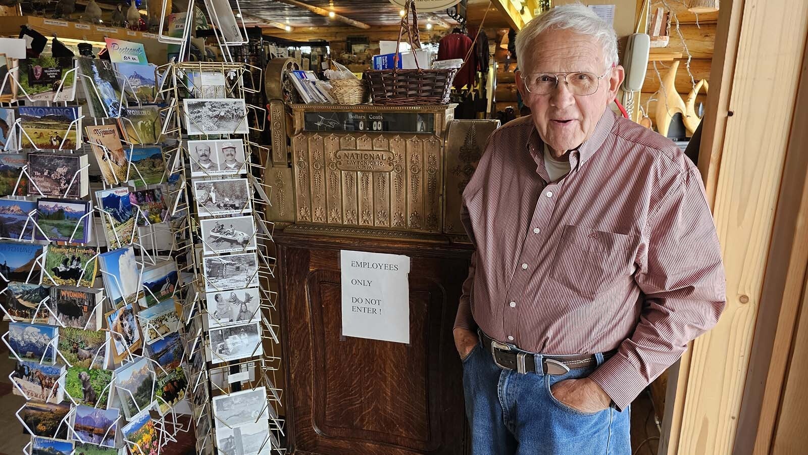 Frank Welty Jr. standing by the NCR cash register still in use at his store.