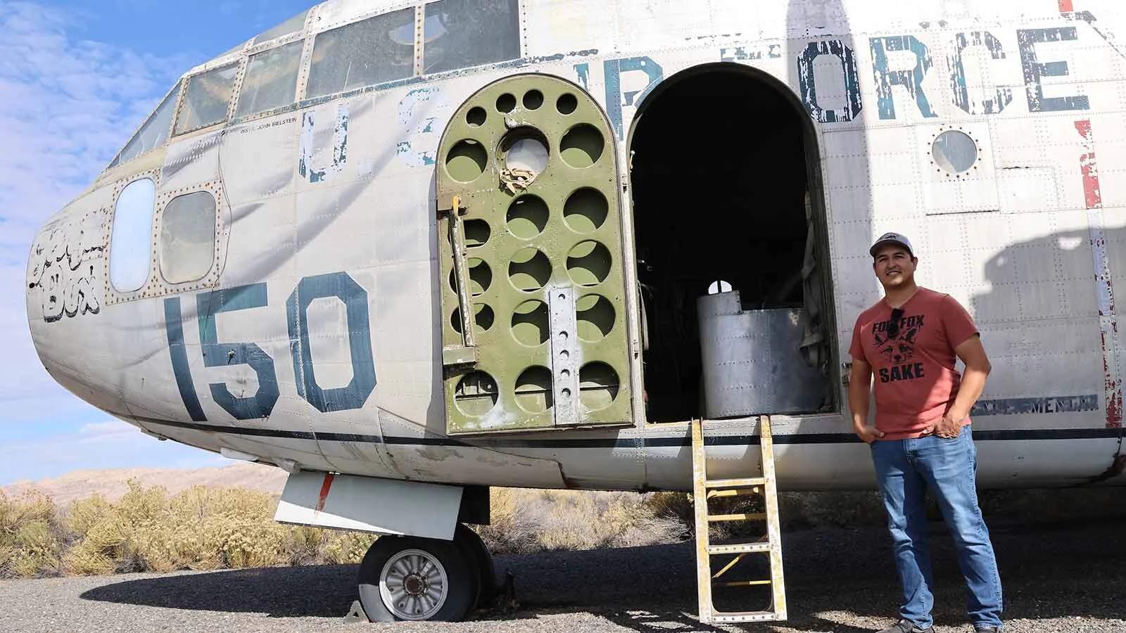 D.J. Hernandez stands outside his newly purchased C-119 “Flying Boxcar” that he hopes to restore to flying condition. 
