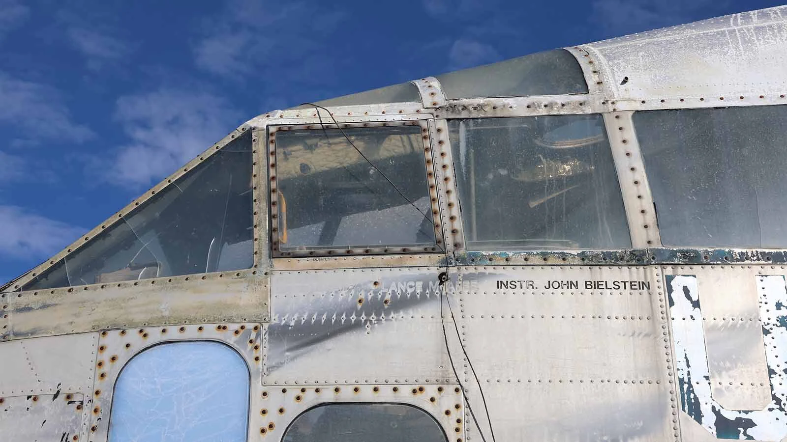 Faded pilot names can be seen on the pilot’s side of the aircraft.