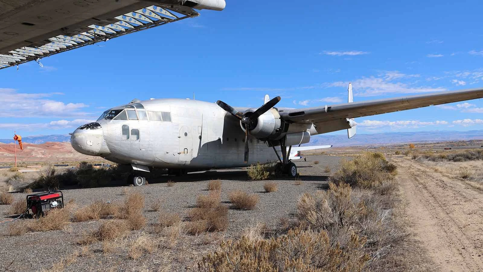 The C-119 that sits behind D.J. Hernandez’s plane may have his plane’s three-blade propeller. 