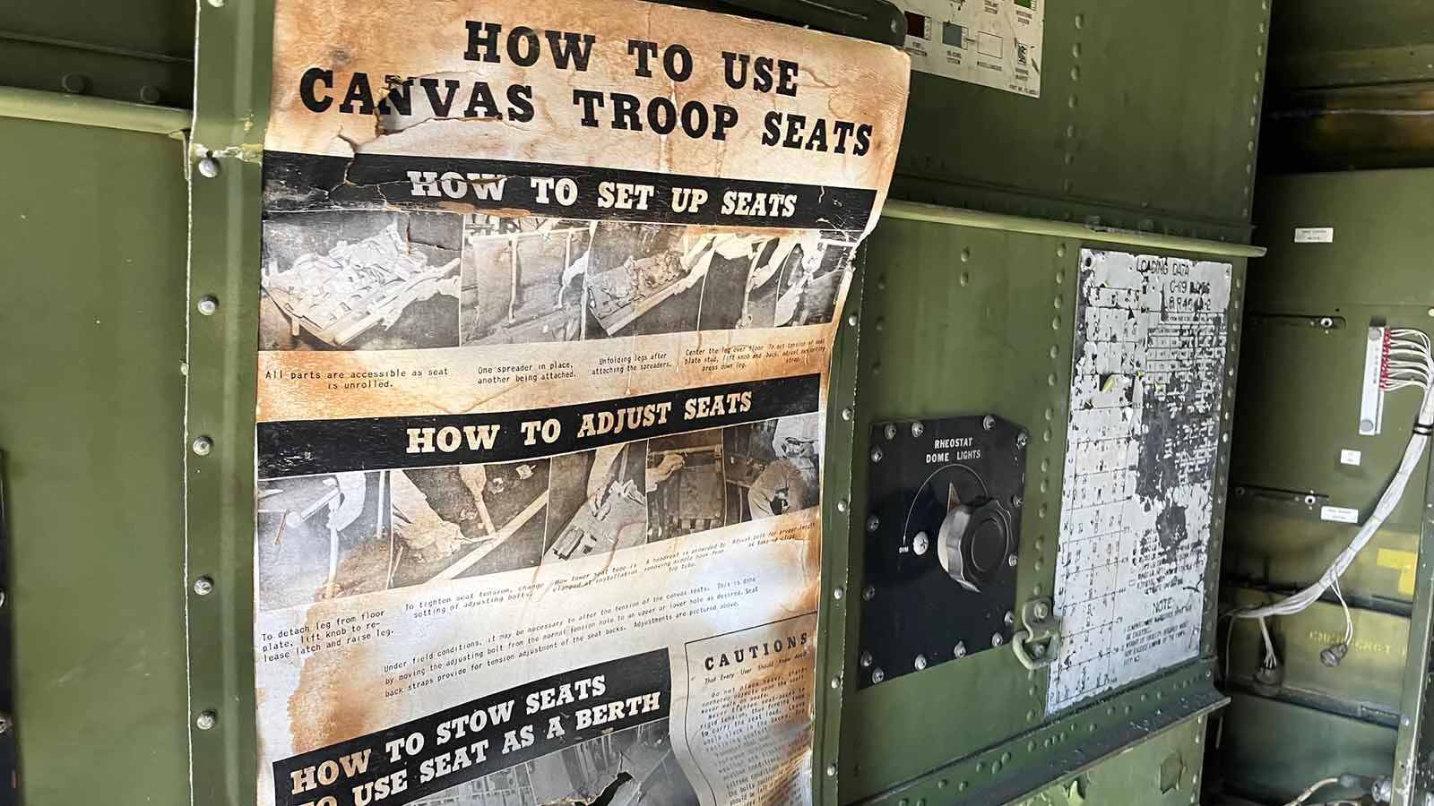 Original instructions for the canvas troop seats that remain in the plane are on the wall of the cargo bay. 