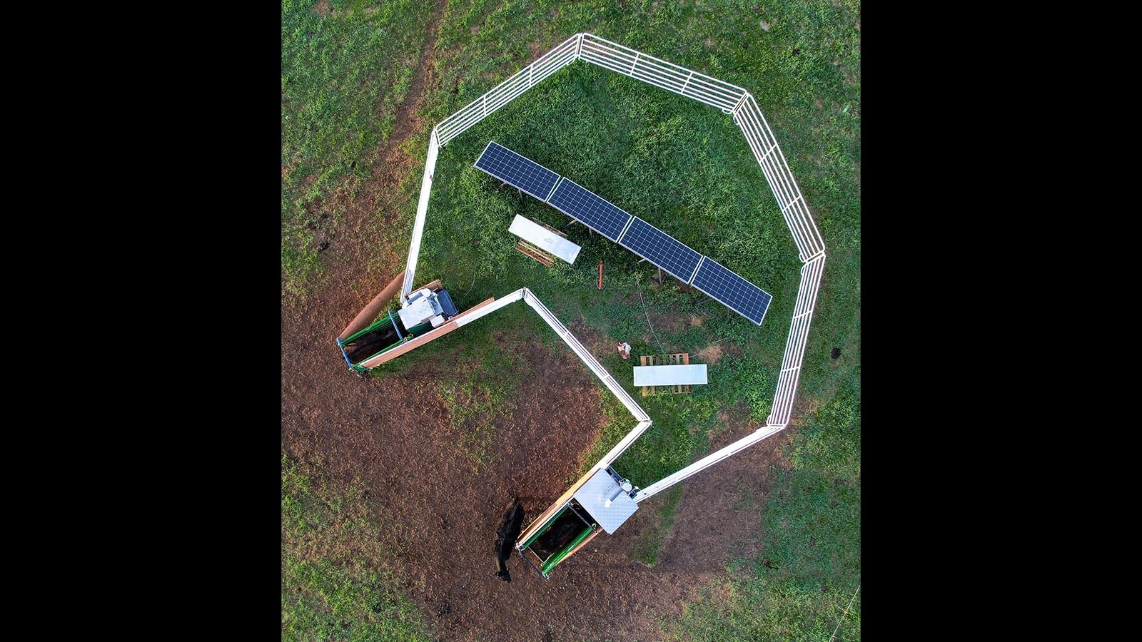 Overhead view of the machines that dispense the seaweed supplement and measure the grazing cattle's methane emissions. The solar panels power the machines.