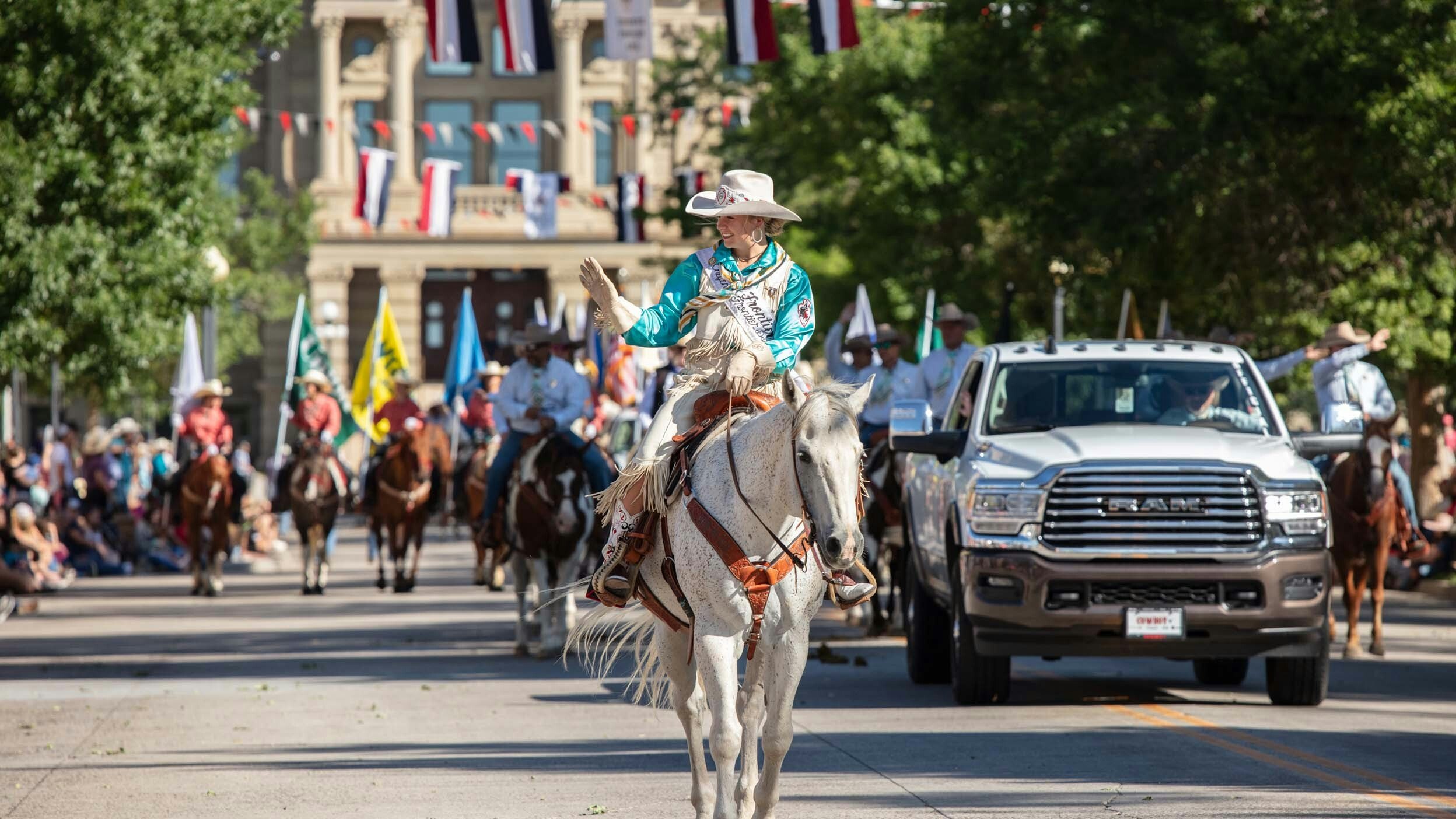 Miss Frontier Jordan Johnson waves at the packed streets of downtown Cheyenne during the parade on July 29, 2023.