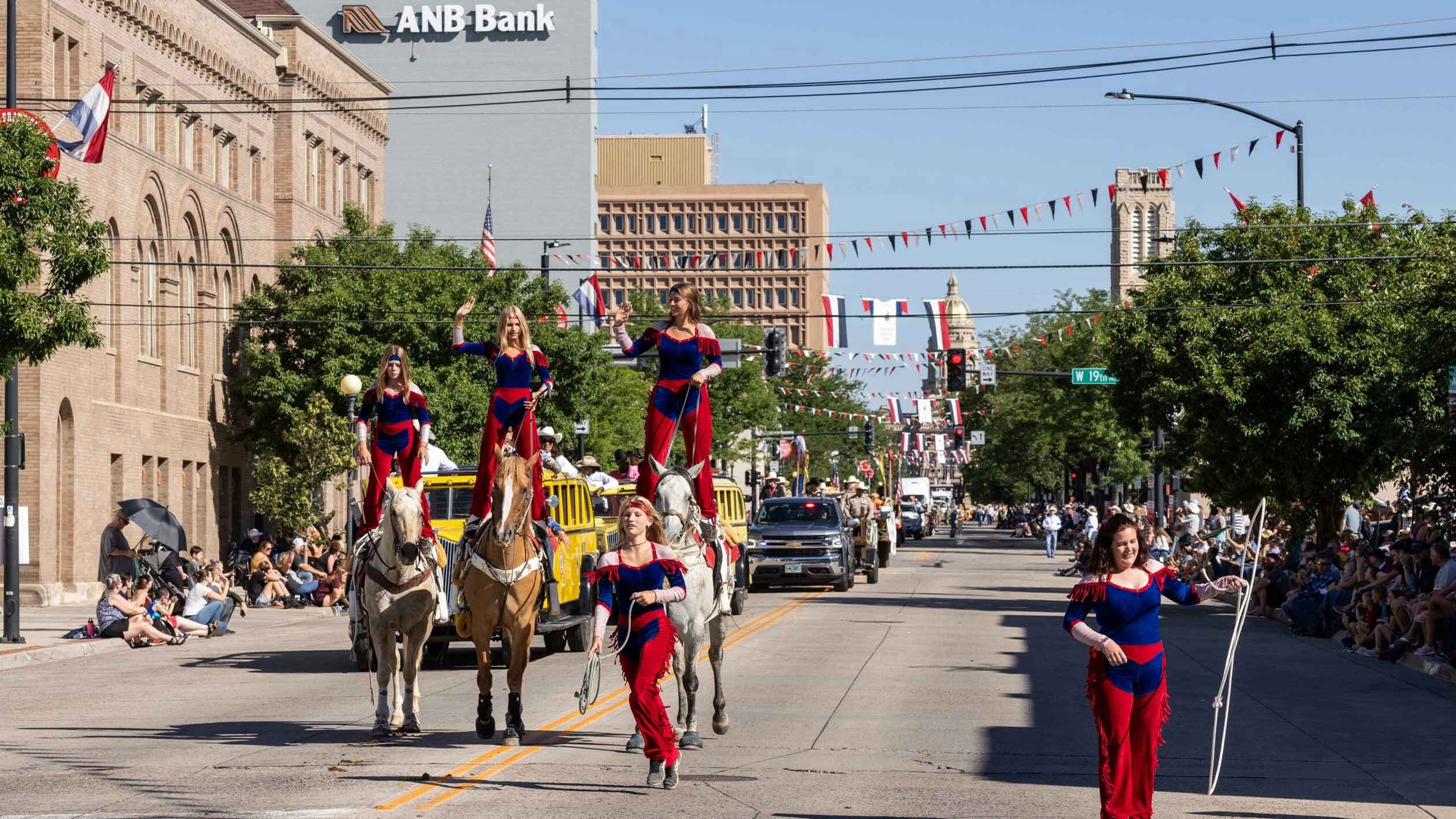 Caption for photo below — Trick riders and ropers perform during the parade at Cheyenne Frontier Days on July 22, 2023 in downtown Cheyenne.